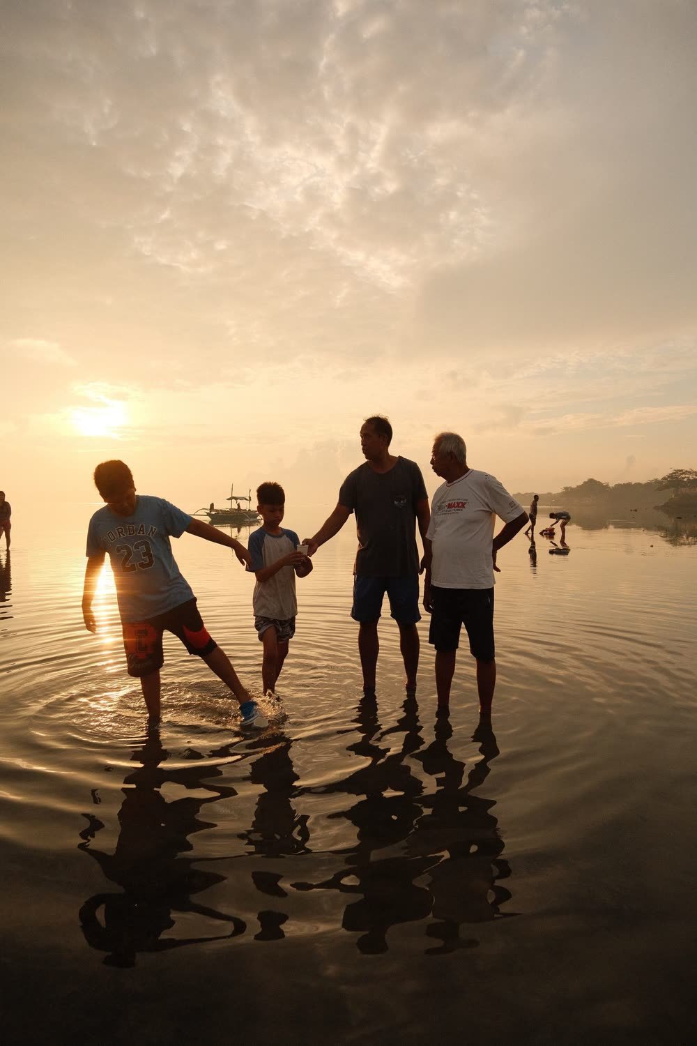 Família na praia ao nascer do sol